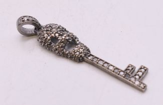 A diamond-set skeleton key pendant. 4.25 cm high.