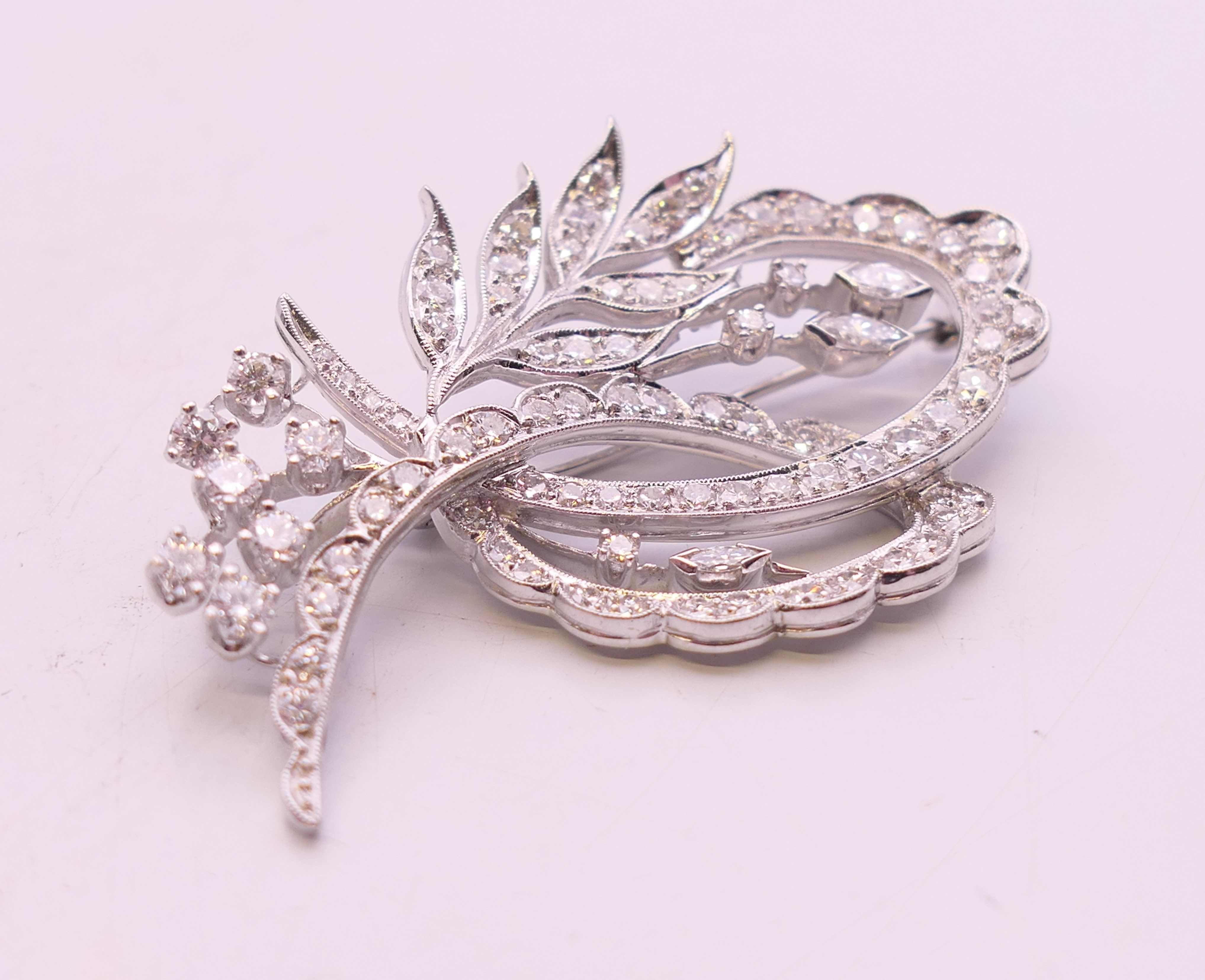 An unmarked white gold or platinum diamond-set floral spray brooch. 5 cm high. - Image 2 of 3