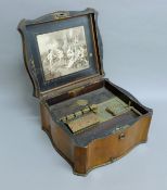 A 19th century walnut-cased polyphon and discs. 36 cm wide.