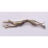 A silver greyhound brooch. 7 cm long.