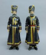 A pair of large cold-painted bronze models of Russian figures. 39.5 cm high.
