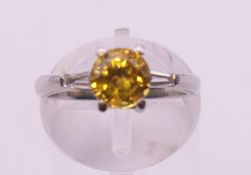 A platinum diamond and yellow sapphire ring. Ring size K/L.