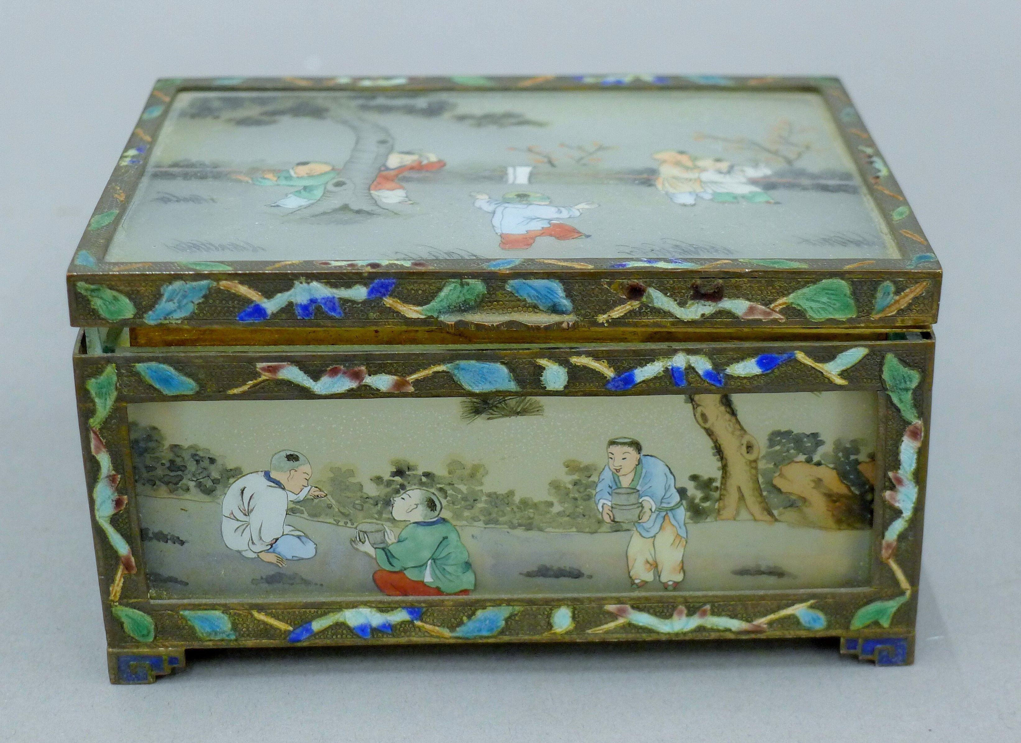 A Chinese enamel decorated glass panel set trinket box. 11 cm wide.