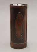 A hardwood brush pot with carving of Shou Lai on a turtle. Verso with a poem. 21 cm high.