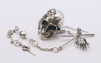 A silver skull watch chain. 28 cm long.