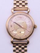 A 9 ct gold Jaeger LeCoultre gentleman's wristwatch. 3.5 cm wide. 52.5 grammes total weight.