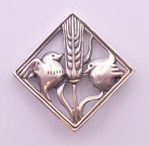 A silver bird and wheatsheaf brooch. 3.5 cm high.