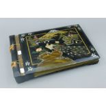 A early 20th century lacquered musical photograph album. 39.5 cm long.