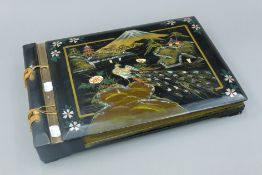 A early 20th century lacquered musical photograph album. 39.5 cm long.