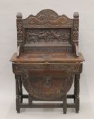 A carved oak single flap side table, the back carved with a scene titled Do Ye Justyce Unto All.