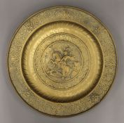 A 19th century brass charger depicting St George and the dragon. 44.5 cm diameter.