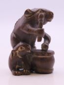 A small carving of a rat drumming. 4 cm high.