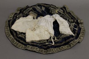 A Victorian blue velvet doll's skirt, embroidered with silver thread,