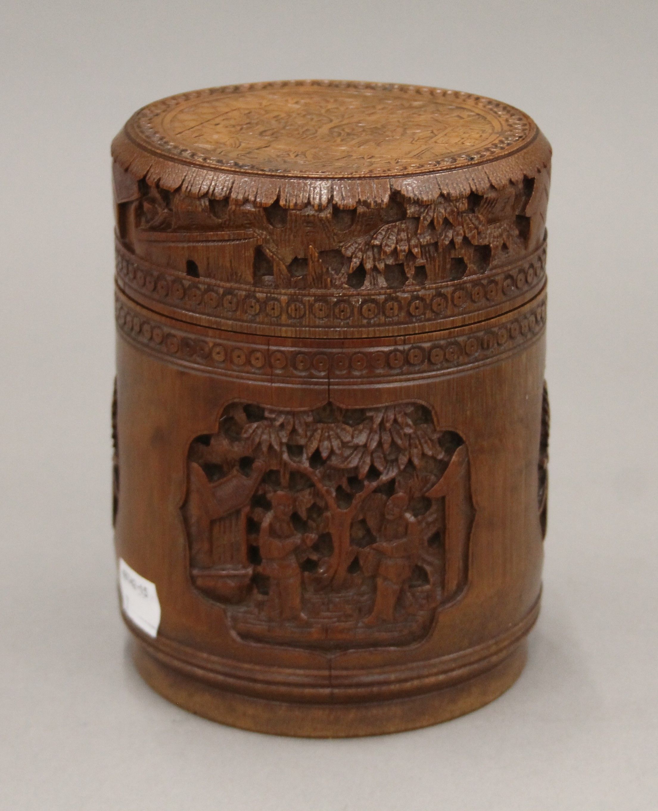 A Chinese cylindrical bamboo box, carved with various figures and mythical beasts,