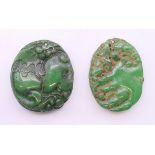 Two jade pendants, each approximately 4.5 cm high.