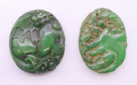 Two jade pendants, each approximately 4.5 cm high.