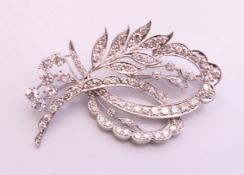 An unmarked white gold or platinum diamond-set floral spray brooch. 5 cm high.