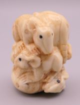 A bone carving formed as rats. 4 cm high.