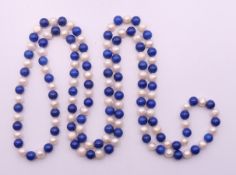 A string of lapiz beads and pearls. 116 cm long.