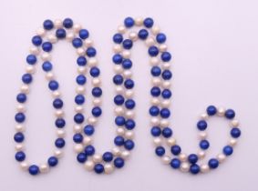 A string of lapiz beads and pearls. 116 cm long.