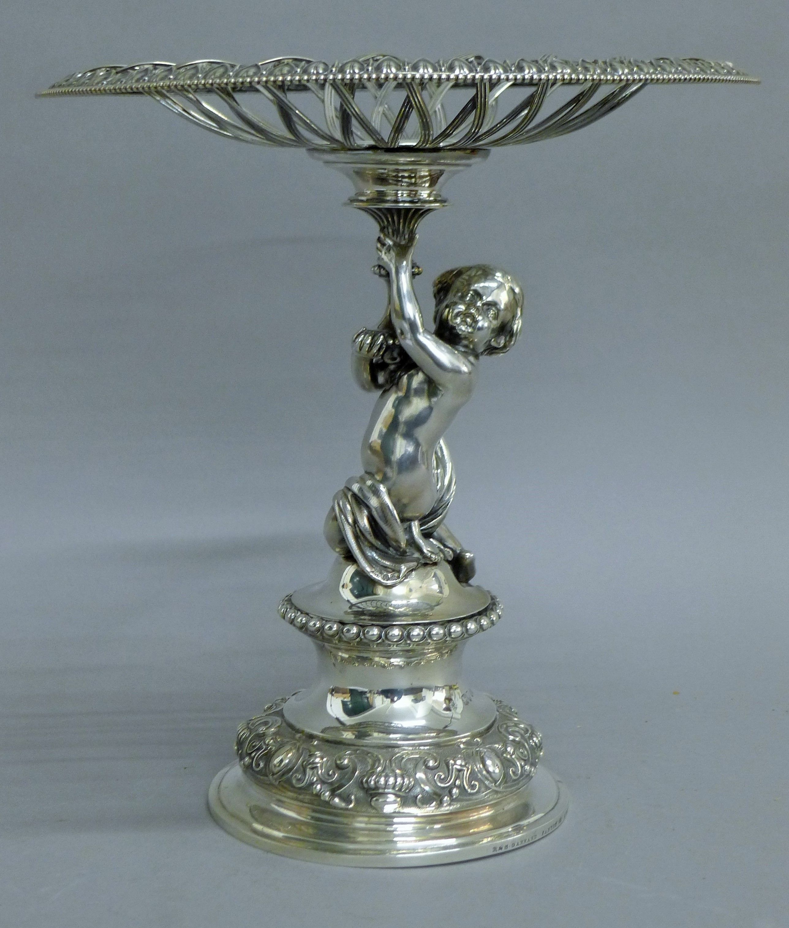 A Victorian silver centrepiece, the stem formed as a putto holding a pierced basket, - Image 2 of 10