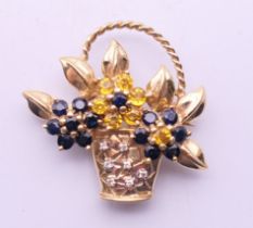 A 14 ct gold diamond, sapphire and citrine floral basket brooch. 3 cm high. 7.