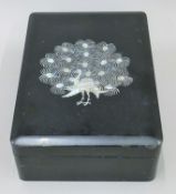 A lacquered box inlaid in mother-of-pearl with a peacock. 33 cm long.