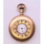 A 14 K gold stiffened half hunter pocket watch. 4 cm diameter.