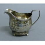 A Georgian silver cream jug. 9 cm high. 121.8 grammes.