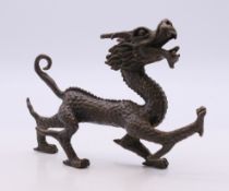 A bronze model of a dragon. 11 cm long.