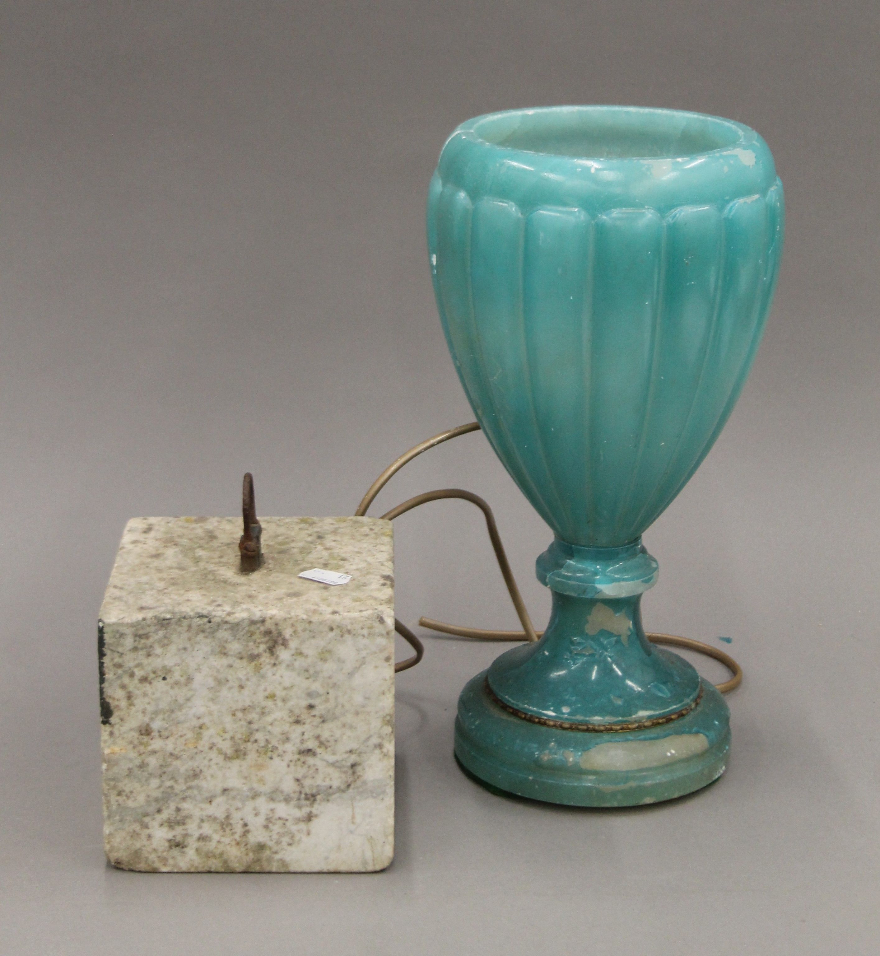 An antique marble tethering block and an alabaster lamp. The latter 34 cm high.