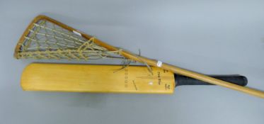 A vintage cricket bat and a lacrosse stick. The latter 113 cm long.