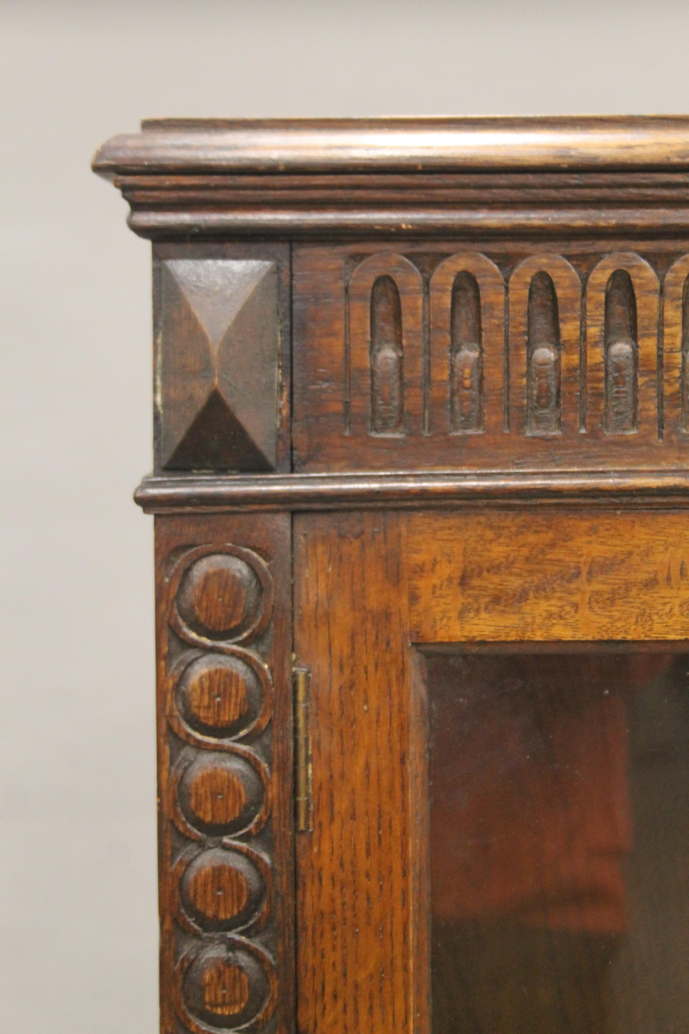 An early 20th century carved oak two door glazed barley twist cabinet. - Image 4 of 5