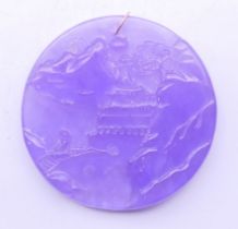 A gold mounted lavender jade pendant. 5.5 cm diameter.
