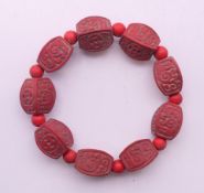 A cinnabar bracelet. 20 cm long.