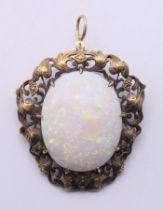 A large opal and gold brooch. 5.5 cm high overall. 15.4 grammes total weight.