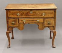 A Georgian walnut dressing table. 107.5 cm wide.