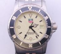 A boxed Tag Heuer full lume dial 1500 sports series gentleman's wristwatch. 4 cm wide.