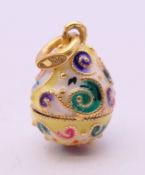 A silver and enamel egg pendant bearing Russian marks. 2 cm high.