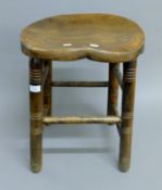 An elm seated stool. 40 cm wide.