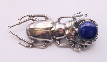 A silver and lapiz beetle brooch. 5.5 cm long.