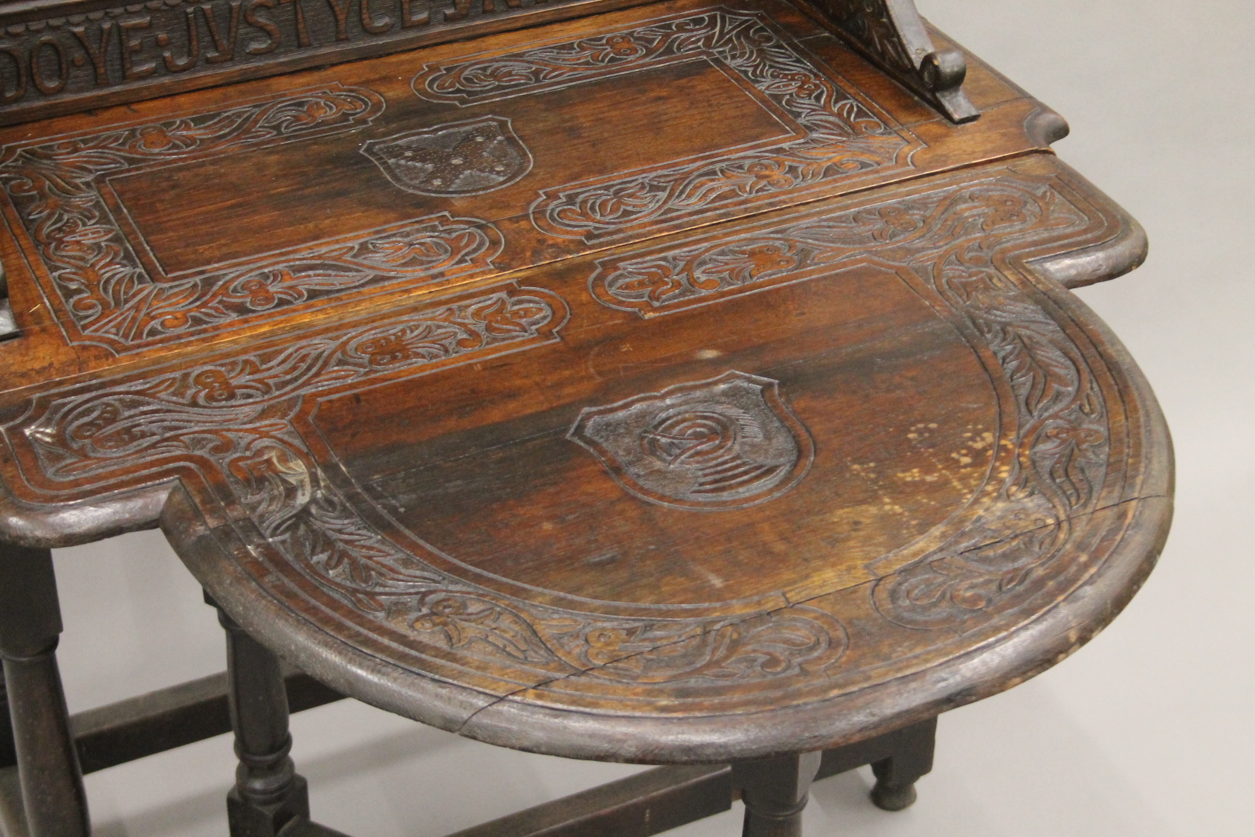 A carved oak single flap side table, the back carved with a scene titled Do Ye Justyce Unto All. - Image 5 of 8