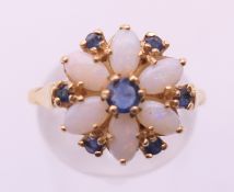 A 14 ct gold opal and sapphire daisy cluster ring. Ring size P.