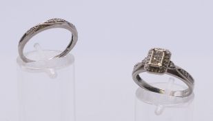 A platinum and diamond engagement ring and a platinum and diamond wedding band. Each ring size O.