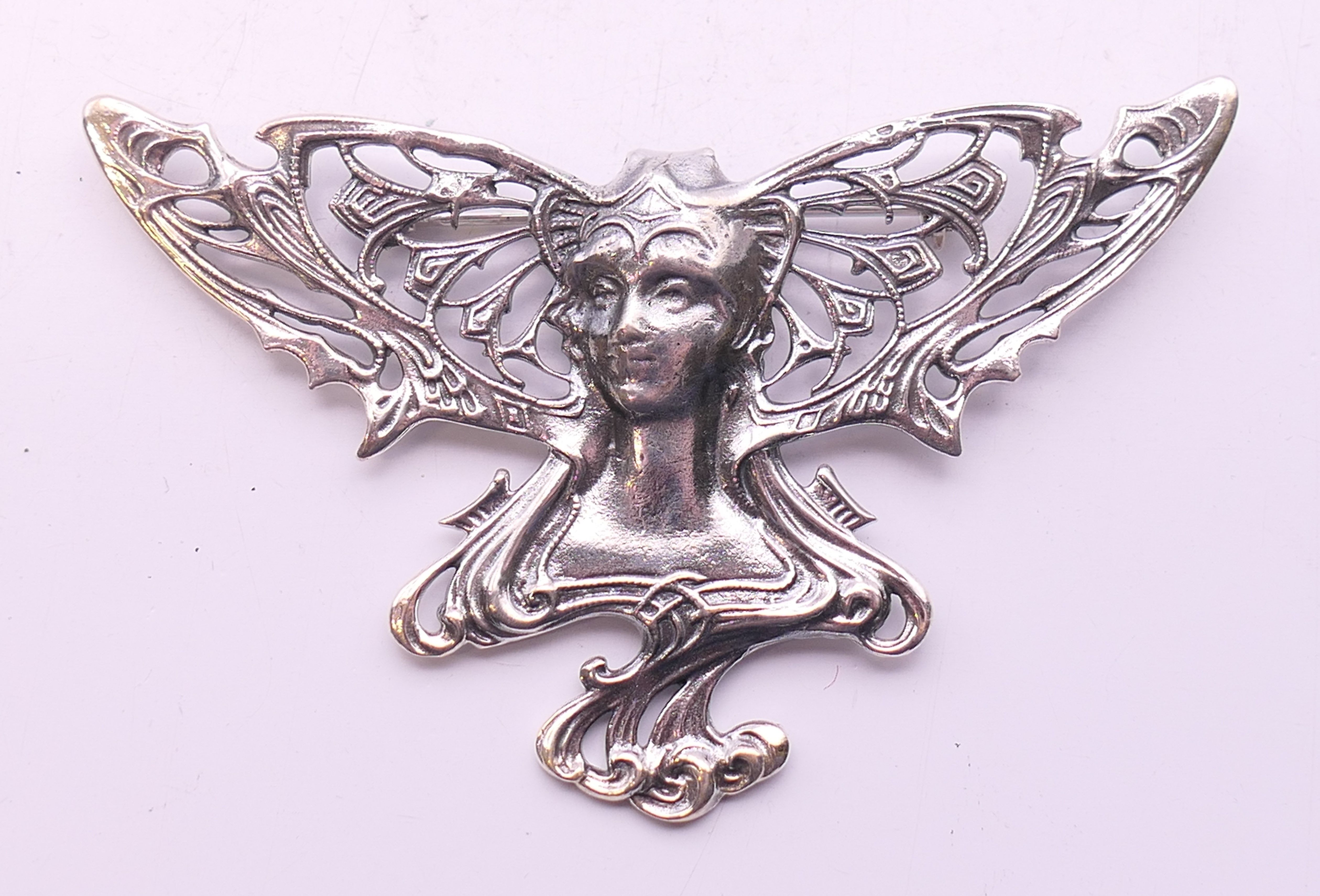 A silver Art Nouveau style girl brooch. 7.5 cm wide.