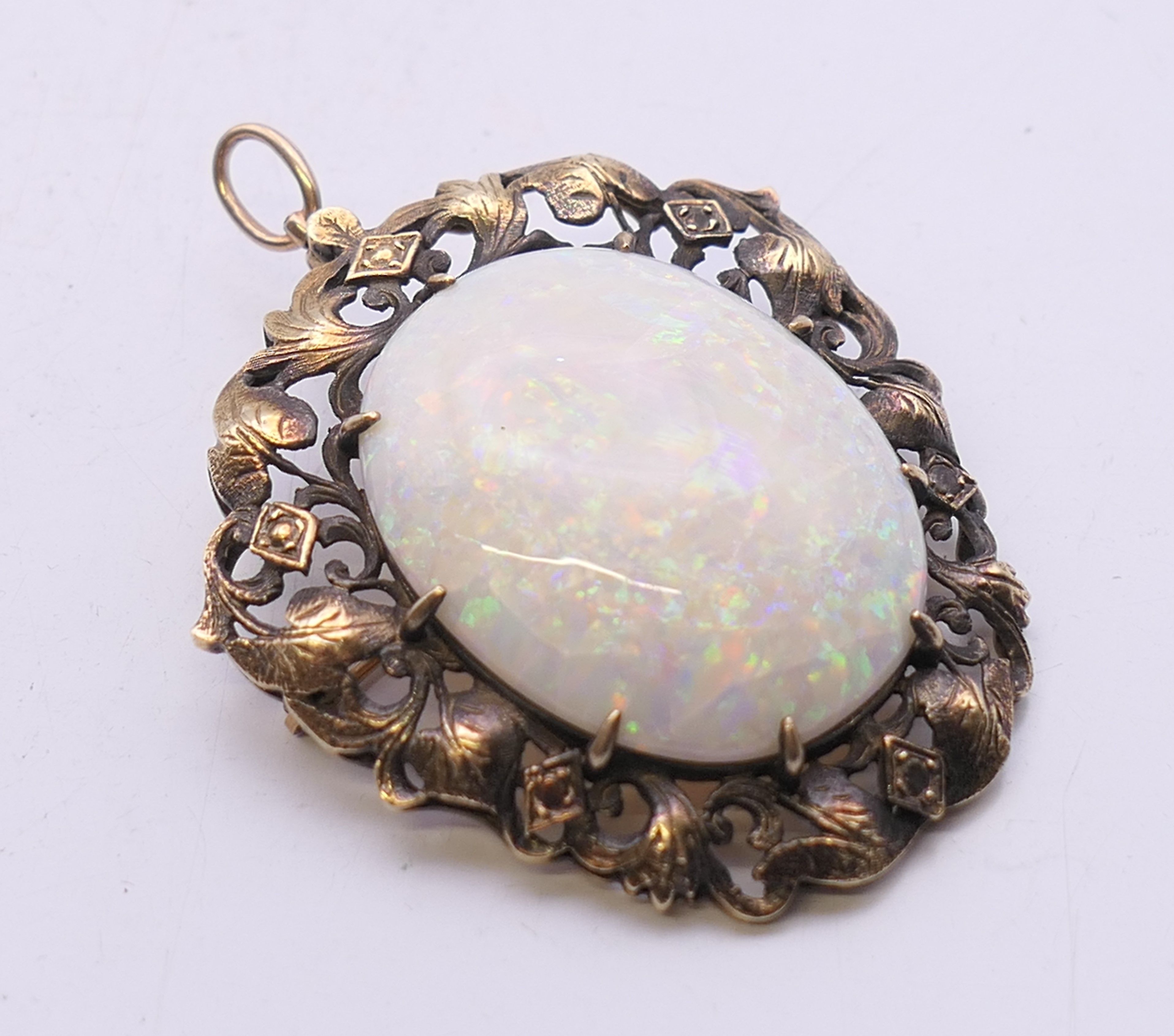 A large opal and gold brooch. 5.5 cm high overall. 15.4 grammes total weight. - Image 2 of 4