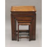A Chinese nest of four carved hardwood tables. 50.5 cm wide.