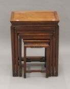 A Chinese nest of four carved hardwood tables. 50.5 cm wide.