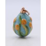 A 14 ct gold mounted enamel egg pendant bearing Russian marks. 2.5 cm high.