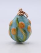 A 14 ct gold mounted enamel egg pendant bearing Russian marks. 2.5 cm high.